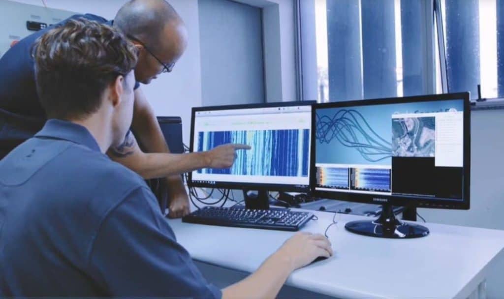 Two Engineers looking at computer data displays