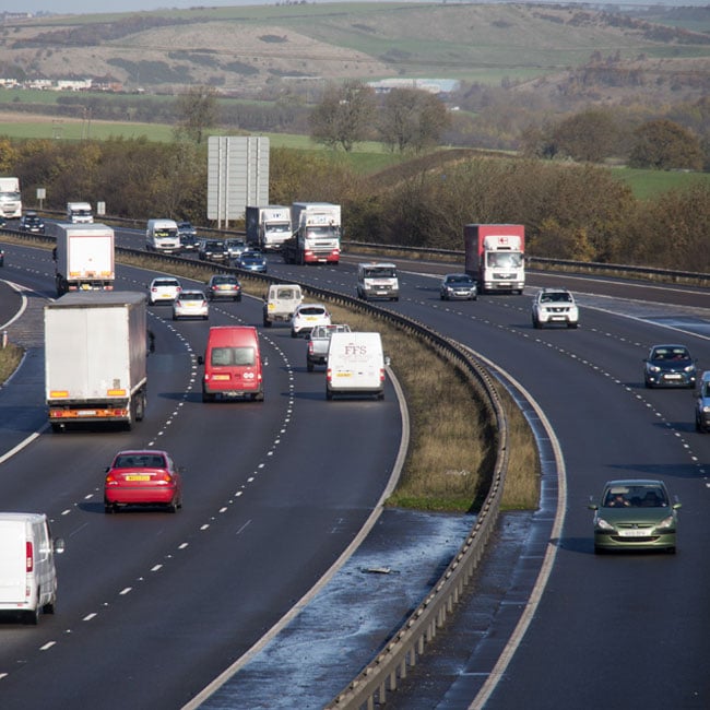 Two lane motorway in UK with hilly countryside in background