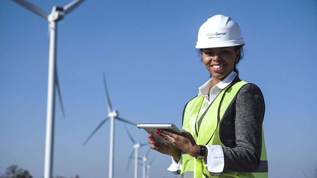 woman looking at table in front of wind turbines