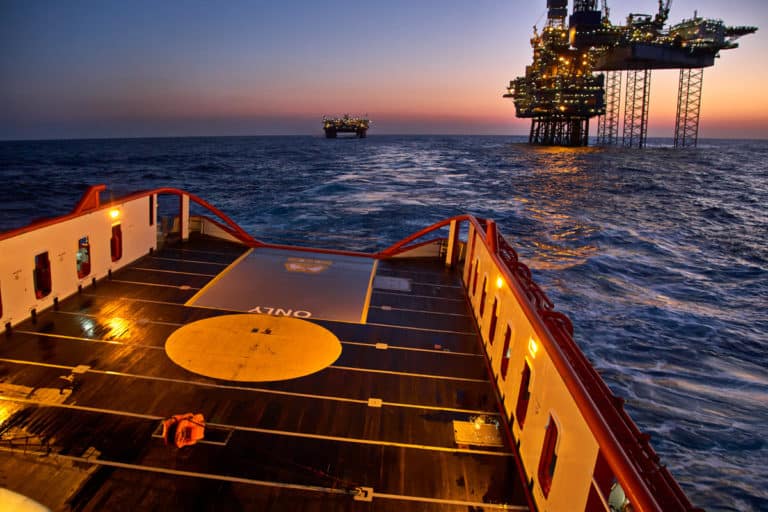 Photo of a Supply ship approaching offshore rig | Fiber-Optic Sensing for measuring oilfield reservoir compaction