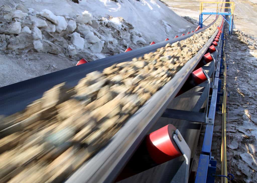 conveyor belt with ore moving rapidly