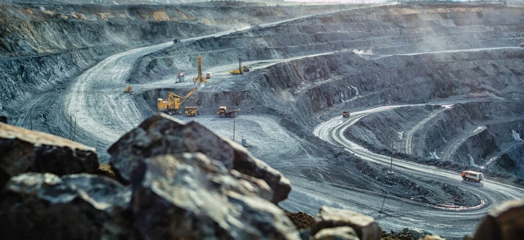 Trucks and escavators in an open pit mine